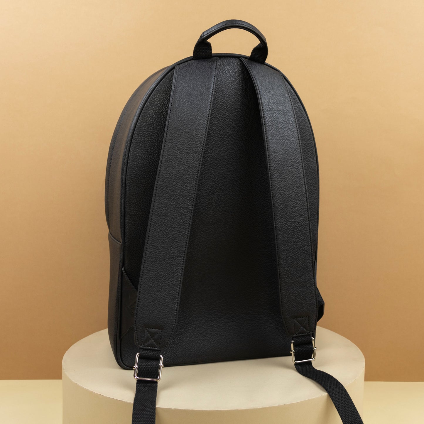 Backpack with adjustable leather straps