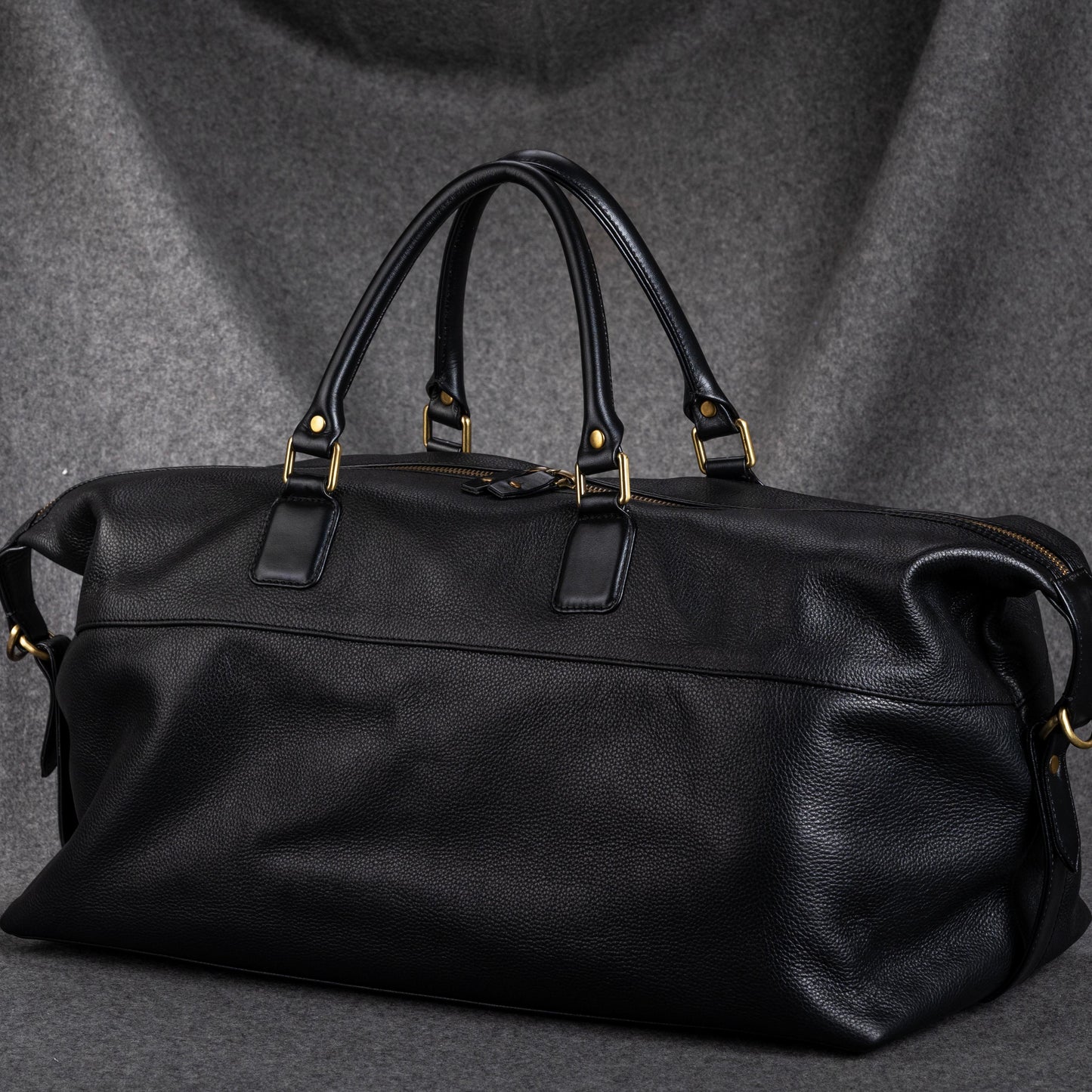 The Duffle Bag is handmade from Leather, in Black. Cabin size, can also be placed overhead bin on the aircraft