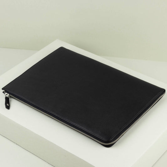Black zippered laptop pouch on a white surface
