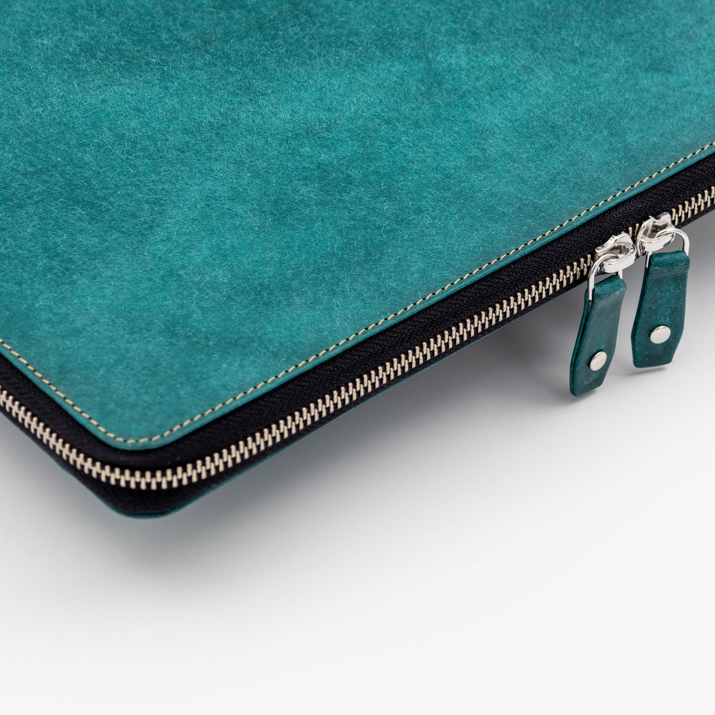 The leather laptop case is designed with a zip around closure. 