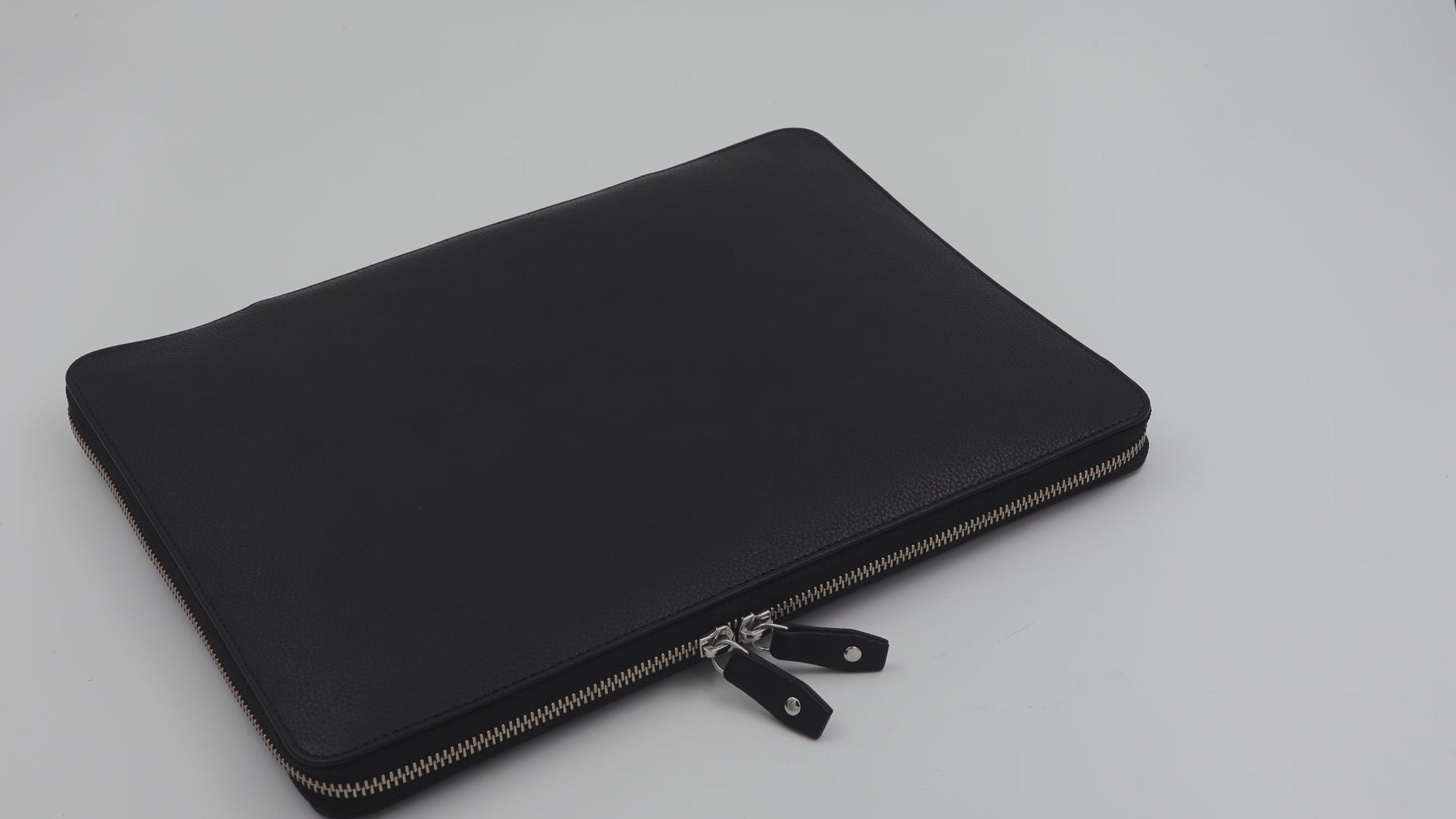 A Leather Laptop Case to carry the MacBook Air 15. Designed with a zip around closure, the case unzips to reveal a spacious interior that lays completely flat. 